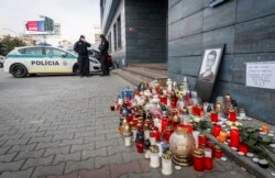 Police guard the entrance to the offices of news website Aktuality.sk, the employer of murdered investigative journalist Jan Kuciak, in Bratislava, Slovakia, Feb. 27, 2018.