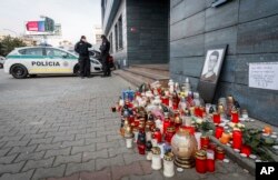 Police guard the entrance to the offices of news website Aktuality.sk, the employer of murdered investigative journalist Jan Kuciak, in Bratislava, Slovakia, Feb. 27, 2018.