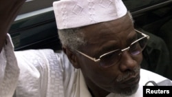 Former Chad President Hissene Habre talks to reporters as he leaves a court in Dakar, Senegal on November 25, 2005.