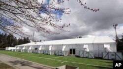 One of a pair of massive temporary buildings meant for use as a field hospital for coronavirus patients stands on a soccer field in the Seattle suburb of Shoreline, Washington, March 24, 2020.