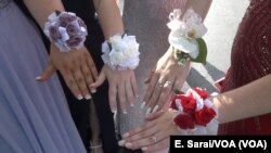 Everyone shows off their manicures and corsages at prom.