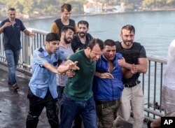 People apprehend a Turkish soldier that participated in the attempted coup, on Istanbul's Bosporus Bridge, July 16, 2016.
