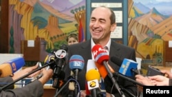 FILE - Armenia's President Robert Kocharyan speaks to the media after casting his ballot during a parliamentary election in Yerevan, May 12, 2007.