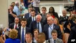 Democratic presidential candidate Sen. Bernie Sanders, I-Vt., accompanied by his wife Jane, right, leaves through the lobby of the Capitol Hilton after meeting with Democratic presidential candidate Hillary Clinton, in Washington, Tuesday, June 14, 2016.