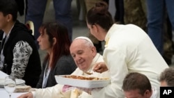 Pope Francis sits at a table during a lunch, in the Paul VI Hall at the Vatican, Nov. 17, 2019. Pope Francis is offering several hundred poor people, homeless, migrants, unemployed a lunch as he celebrates the World Day of the Poor.