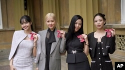 From left, Lisa (Lalisa Manoban), Rose (Roseanne Park), Jisoo Kim and Jennie Kim, from the K-Pop band Blackpink pose with their Honorary Members of the Order of the British Empire, awarded in recognition of the band's role as COP26 advocates in London, Nov. 22, 2023. 