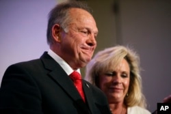 FILE - Former Alabama Chief Justice and U.S. Senate candidate Roy Moore speaks at a news conference with his wife Kayla Moore, in Birmingham, Ala., Nov. 16, 2017.