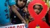 Children walk with activists in a torch light rally ahead of World AIDS Day in Kolkata, India, November 30, 2012. The activists demanded monthly pensions and free ration facilities for sex workers and HIV/AIDS-affected people. 