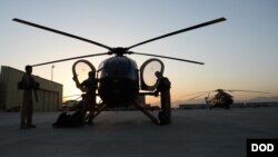 FILE - Afghan Air Force pilots perform preflight inspections prior to taking off with an all-Afghan crew for a combat mission, Sept. 27, 2015.