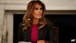 First lady Melania Trump speaks during a roundtable on cyberbullying in the State Dining Room of the White House, March 20, 2018, in Washington.