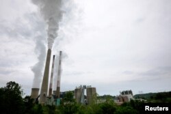 Exhaust rises from the stacks of the Harrison Power Station in Haywood, West Virginia, May 16, 2018.