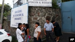 Un grupo de personas esperan fuera de la Dirección de Atención al Migrante en San Salvador, El Salvador, lugar al que llegan los salvadoreños deportados por vía terrestre, especialmente desde México. Foto AP.
