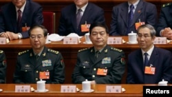 China's newly-elected Defense Minister Chang Wanquan (front row, C) sits together with other delegates as he attends the sixth plenary meeting of the National People's Congress (NPC) at the Great Hall of the People in Beijing, March 16, 2013. 