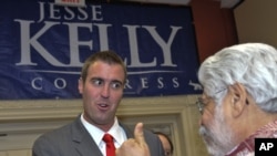 U.S. Republican Congressional candidate Jesse Kelly greets supporters Tuesday, Nov. 2, 2010, at an election night rally in Tucson, Ariz.