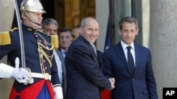 France's President Nicolas Sarkozy, right, with Libyan National Transitional Council's Mustafa Abdel Jalil after a meeting at the Elysee Palace, Paris, April 20, 2011