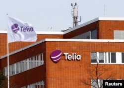 FILE - A flag flutters at the Telia telecommunication company headquarters in Helsinki, Finland, May 5, 2017.