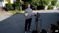 Peter Theo Curtis reads a statement to reporters outside his mother's home in Cambridge, Mass., Aug. 27, 2014.