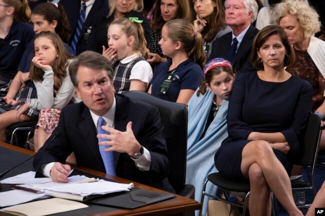 FILE - Supreme Court nominee Brett Kavanaugh testifies before the Senate Judiciary Committee on the third day of his confirmation hearing as he is joined by, from right to left, his wife Ashley Estes Kavanaugh, and their daughters.