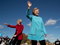 Democratic presidential candidate Hillary Clinton, right, accompanied by Sen. Elizabeth Warren, D-Mass., wave as they arrive at a rally at St. Anselm College in Manchester, N.H., Oct. 24, 2016.