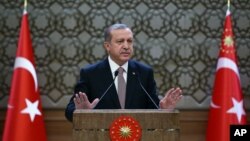 FILE - Turkish President Recep Tayyip Erdogan speaks to local administrators at his palace in Ankara, Turkey, Nov. 26, 2015. He voiced regret Nov. 28 about Turkey's downing of a Russian warplane.