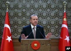 FILE - Turkish President Recep Tayyip Erdogan speaks to local administrators at his palace in Ankara, Turkey, Nov. 26, 2015. He voiced regret Nov. 28 about Turkey's downing of a Russian warplane.