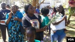 Itai Dzamara's wife, Sheffra with her children and some civil society activists.
