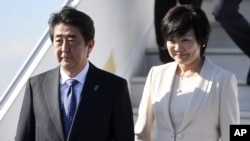 Japanese Prime Minister Shinzo Abe and his wife, Akie, arrive at the Helsinki International Airport in Vantaa, Finland, July 9, 2017, the second leg of Abe's Nordic tour. Abe's approval ranking has fallen at home.