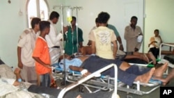 Injured Yemenis lie on stretchers at a hospital in the southern town of Zinjibar after suspected al-Qaeda gunmen launched simultaneous attacks on the intelligence and security services headquarters, 14 Jul 2010