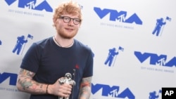 Ed Sheeran poses in the press room with the award for artist of the year at the MTV Video Music Awards at The Forum on Aug. 27, 2017, in Inglewood, Calif. 