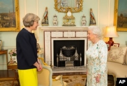 Queen Elizabeth II speaks with Theresa May, left, at the start of an audience in Buckingham Palace, London, where she invited the former Home Secretary to become Prime Minister and form a new government, Wednesday July 13, 2016.