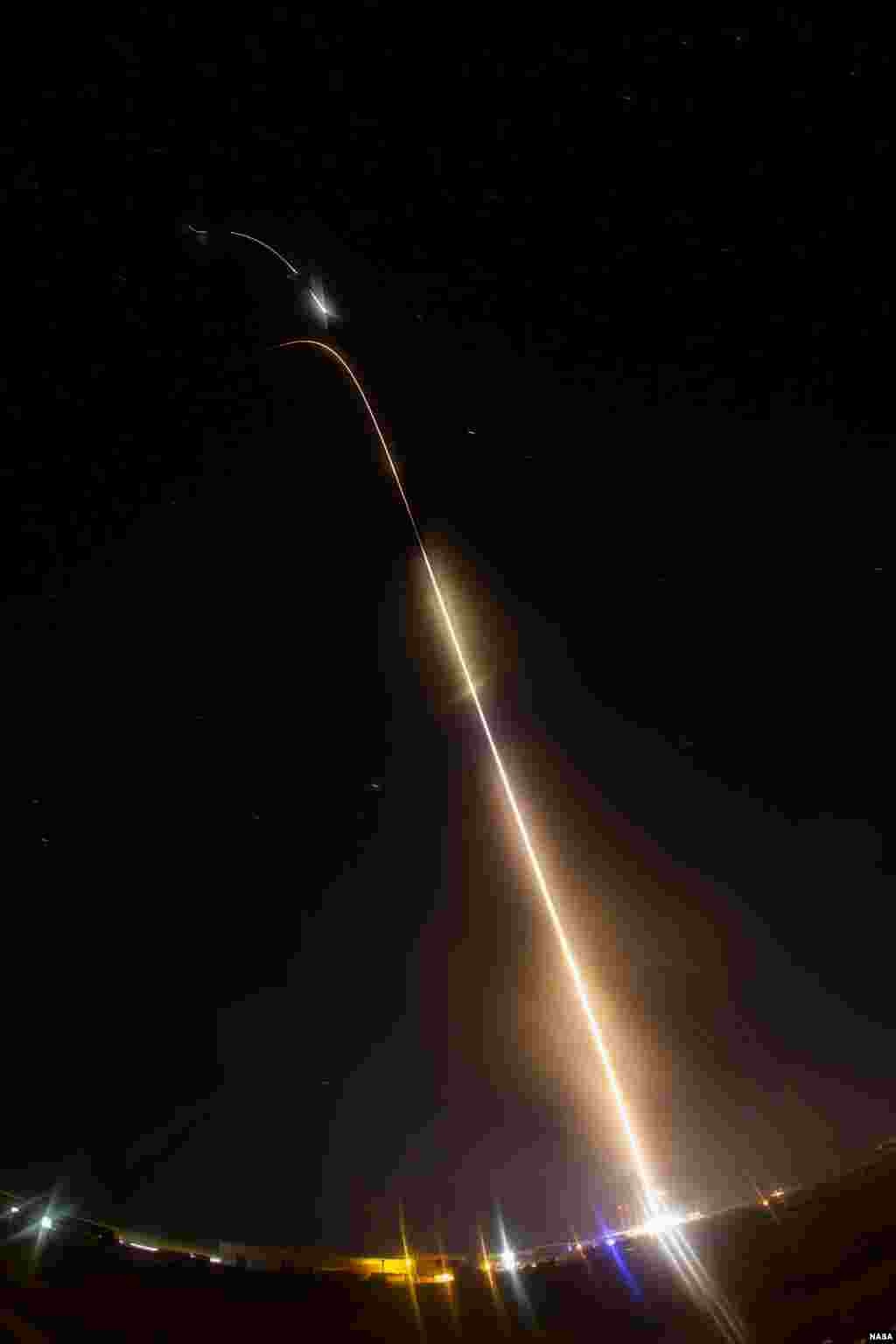 A NASA Black Brant XII suborbital rocket streaks into the night sky following its launch at 11:05 p.m. EDT on June 5, 2013 from the Wallops Flight Facility in Virginia. The rocket carried the Cosmic Infrared Background ExpeRiment (CIBER) to an altitude of approximately 358 miles above the Atlantic Ocean by the four-stage rocket.