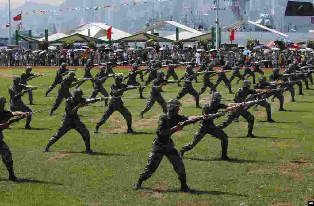 Chinese People&#39;s Liberation Army (PLA) personnel demonstrate during the opening day of Stonecutter Island Navy Base. The opening marks the 18th anniversary of the Hong Kong handover to China, in Hong Kong, July 1, 2015.