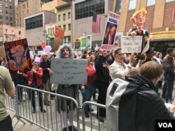 Signs are displayed at the New York City march, where protesters called on President Donald Trump to release his tax returns, April 15, 2017.