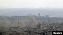Smoke rises in the city of Latakia. Syrian tanks and navy ships shelled the main Mediterranean port city of Latakia on Sunday, residents and rights groups said, killing 24 people as President Bashar al-Assad's forces launched an offensive by land and sea