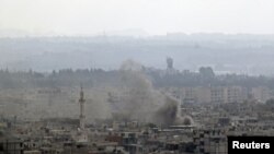 Smoke rises in the city of Latakia. Syrian tanks and navy ships shelled the main Mediterranean port city of Latakia on Sunday, residents and rights groups said, killing 24 people as President Bashar al-Assad's forces launched an offensive by land and sea 