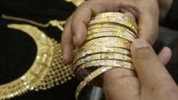 A buyer in Jammu, India chooses gold jewelry
