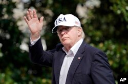 FILE - President Donald Trump waves as he walks across the South Lawn of the White House in Washington, Aug. 27, 2017, following his return after spending the weekend at nearby Camp David, Md.