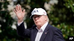 President Donald Trump waves as he walks across the South Lawn of the White House in Washington, Sunday, Aug. 27, 2017, following his return after spending the weekend at nearby Camp David, Maryland. 