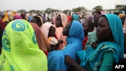 This photo taken on June 15, 2012, at the Jamam refugee camp, shows mothers queueing at a Medecin Sans Frontiere (MSF) field hospital in South Sudan's Upper Nile state, where over 100,000 refugees have fled conflict in Sudan's Blue Nile state since Sept.
