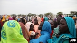 This photo taken on June 15, 2012, at the Jamam refugee camp, shows mothers queueing at a Medecin Sans Frontiere (MSF) field hospital in South Sudan's Upper Nile state.