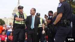 El congresista Luis Gutiérrez junto a decenas de personas cometieron actos de desobediencia civil para ser arrestados y llamar la atención ante la falta de una reforma del sistema de inmigración.[Foto Mitzi Macias, VOA].