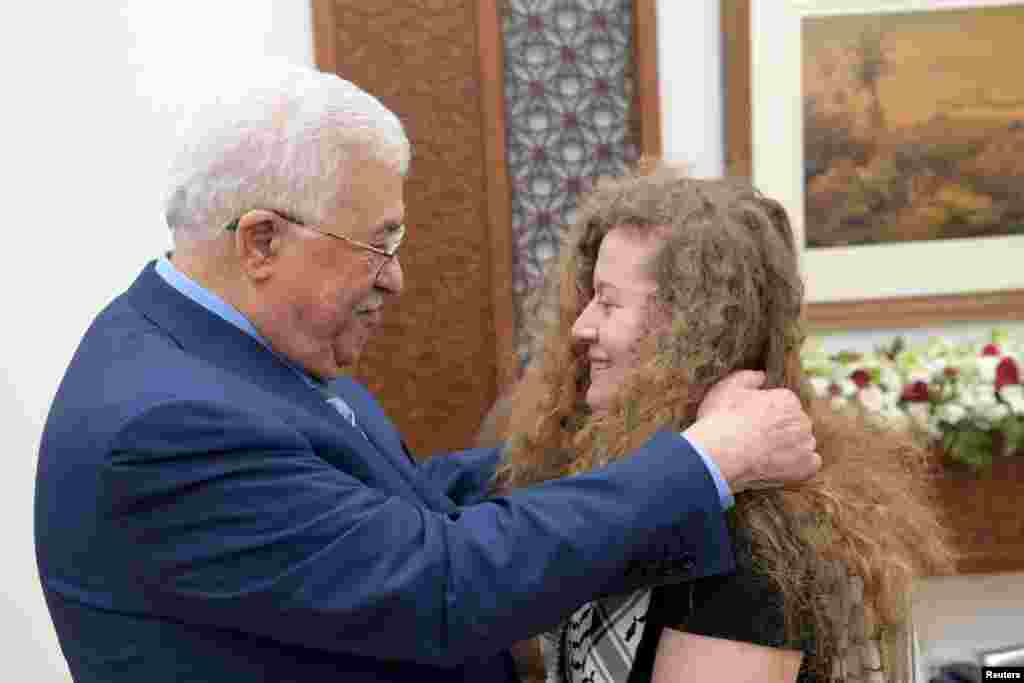 Palestinian President Mahmoud Abbas meets with freed Palestinian teenager Ahed Tamimi after she was released from an Israeli prison, in Ramallah in the occupied West Bank. Israel released the 17-year-old from prison at the end of her eight-month sentence for slapping and kicking Israeli soldiers.