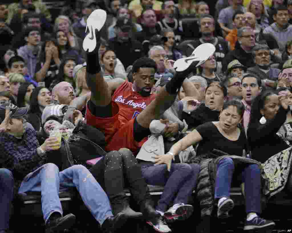 Los Angeles Clippers&rsquo; DeAndre Jordan falls into a row of fans during the first half of an NBA basketball game against the San Antonio Spurs in San Antonio, Texas, Jan. 31, 2015.