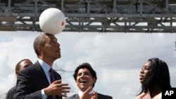 U.S. President Barack Obama demonstrates "the Soccket Ball," which uses kinetic energy to provide power in Africa. (File)