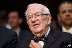 FILE - In this April 30, 2014, file photo, retired Supreme Court Justice John Paul Stevens appears before the Senate Rules Committee on Capitol Hill in Washington.