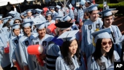 Students participate in a graduation ceremony at Columbia University in New York, May 17, 2017. (AP Photo/Seth Wenig)