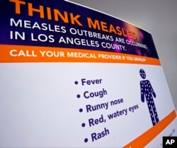 A poster released by Los Angeles County Department of Public Health is seen as experts answer questions regarding the measles response and the quarantine orders in Los Angeles, April 26, 2019