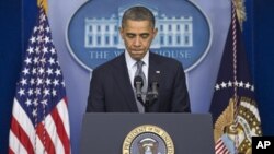 President Barack Obama pauses as he talks about the Connecticut elementary school shooting, in the White House briefing room in Washington, December 14, 2012.