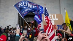 FILE - Insurrections loyal to President Donald Trump riot outside the Capitol, Jan. 6, 2021, in Washington. 