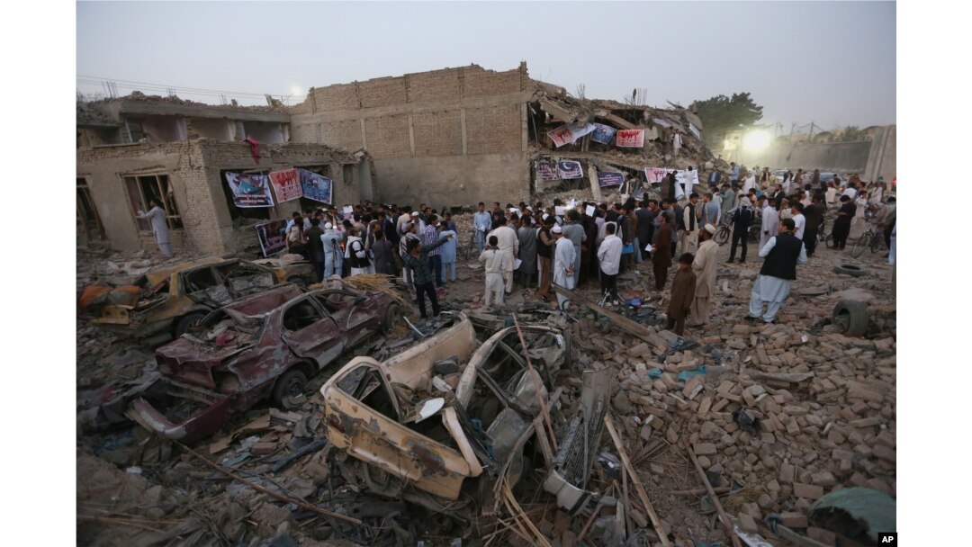 Afghan civil society members light candles during a vigil for victims of Friday's attacks, while gathering at the site of a truck bomb attack in Kabul, Afghanistan, Aug. 8, 2015.